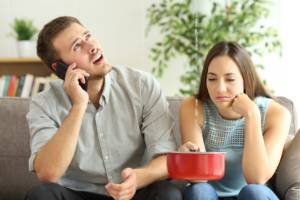 Couple calling home insurance company for leaks